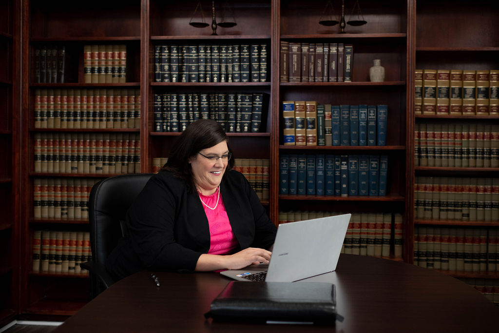Join Our Team | The Harris Firm LLC Attorney Julia Collins of The Harris Firm LLC working at her desk