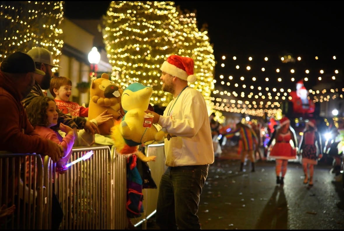 Attorney John Tyler Winans handing out toys from The Harris Firm LLC float at the 2025 Prattville Christmas Parade